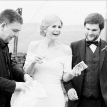 Wedding Magician Darren Brand entertaining a bride and groom at their wedding. The bride looks amazed.